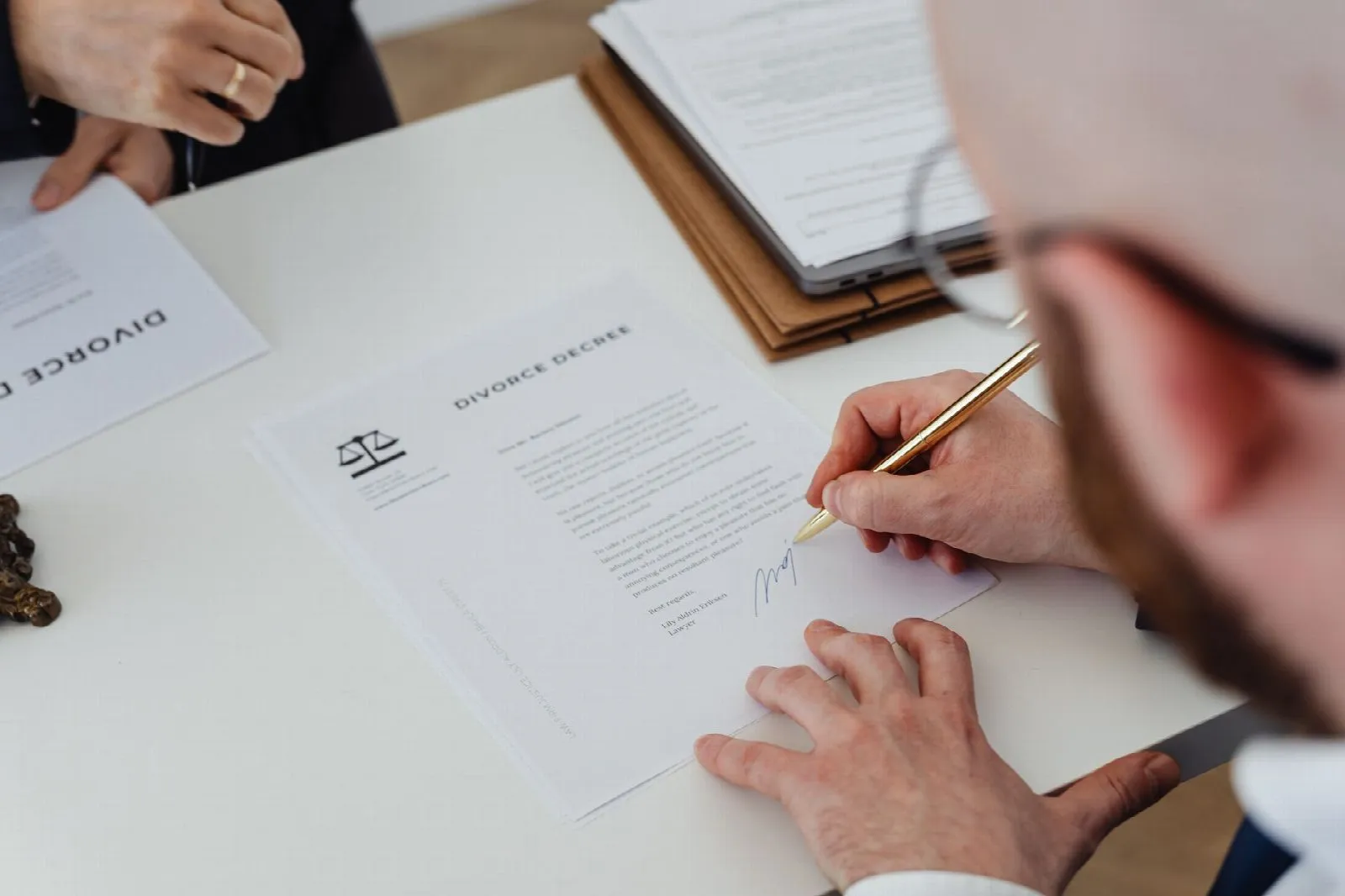 Close-up of a person signing a document